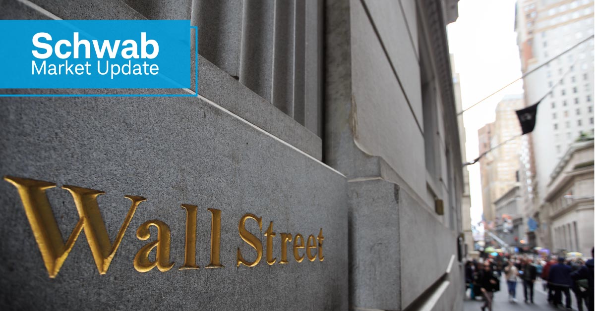 Schwab Market Update: The side of a building on Wall Street with the words "Wall Street" in gold letters. 